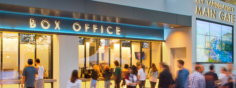 Box office entrance with signage and crowd